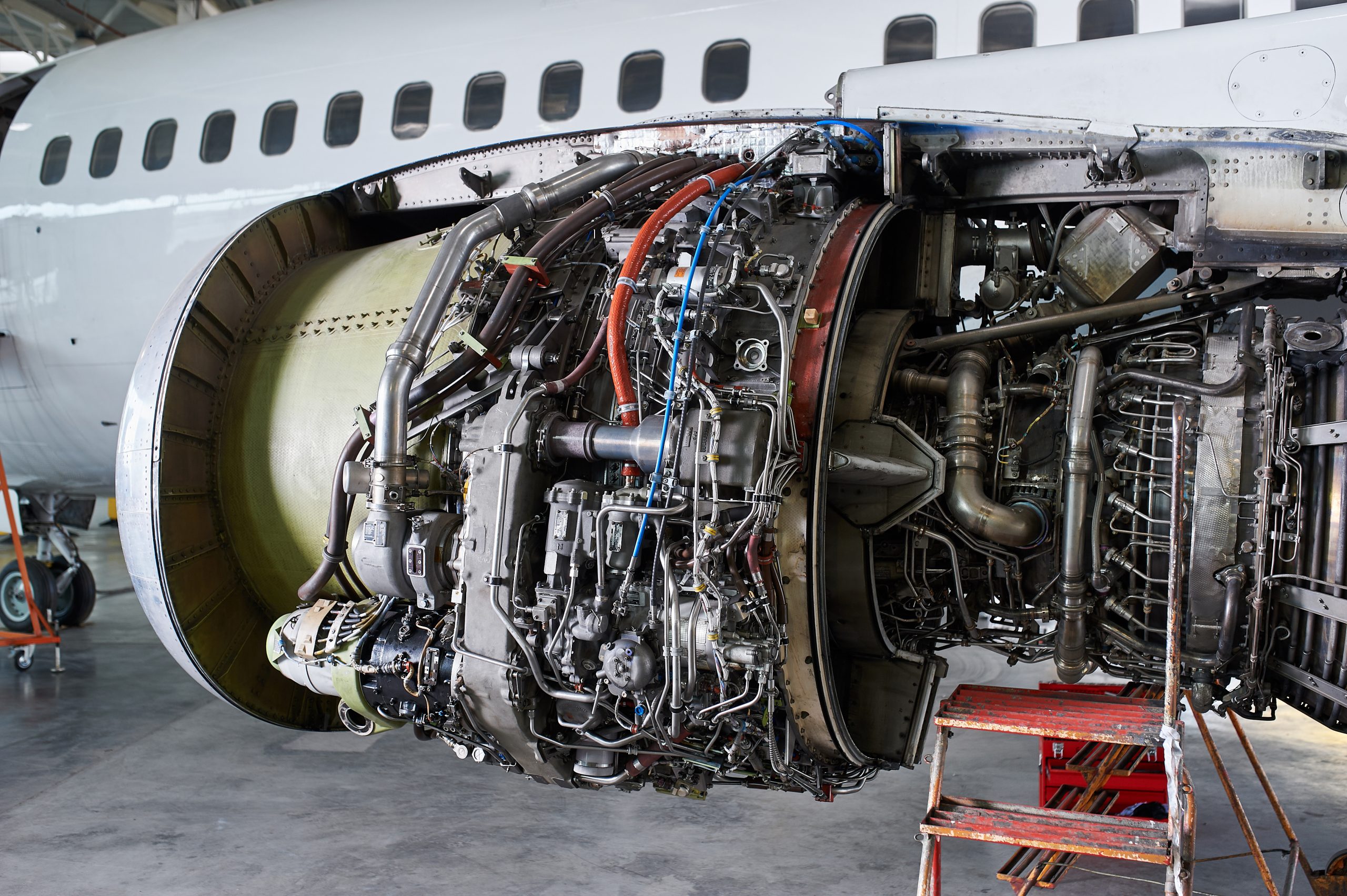 Aircraft engine exposed for maintenance in hangar